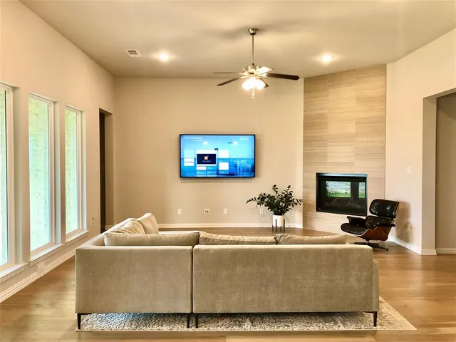 a living room with fireplace furniture and a flat screen tv