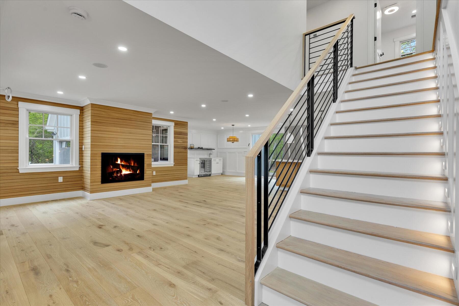 152 Pleasant Bay Road Harwich, MA 02645 - Photo 19 of 97 a view of an empty room with wooden floor and a fireplace
