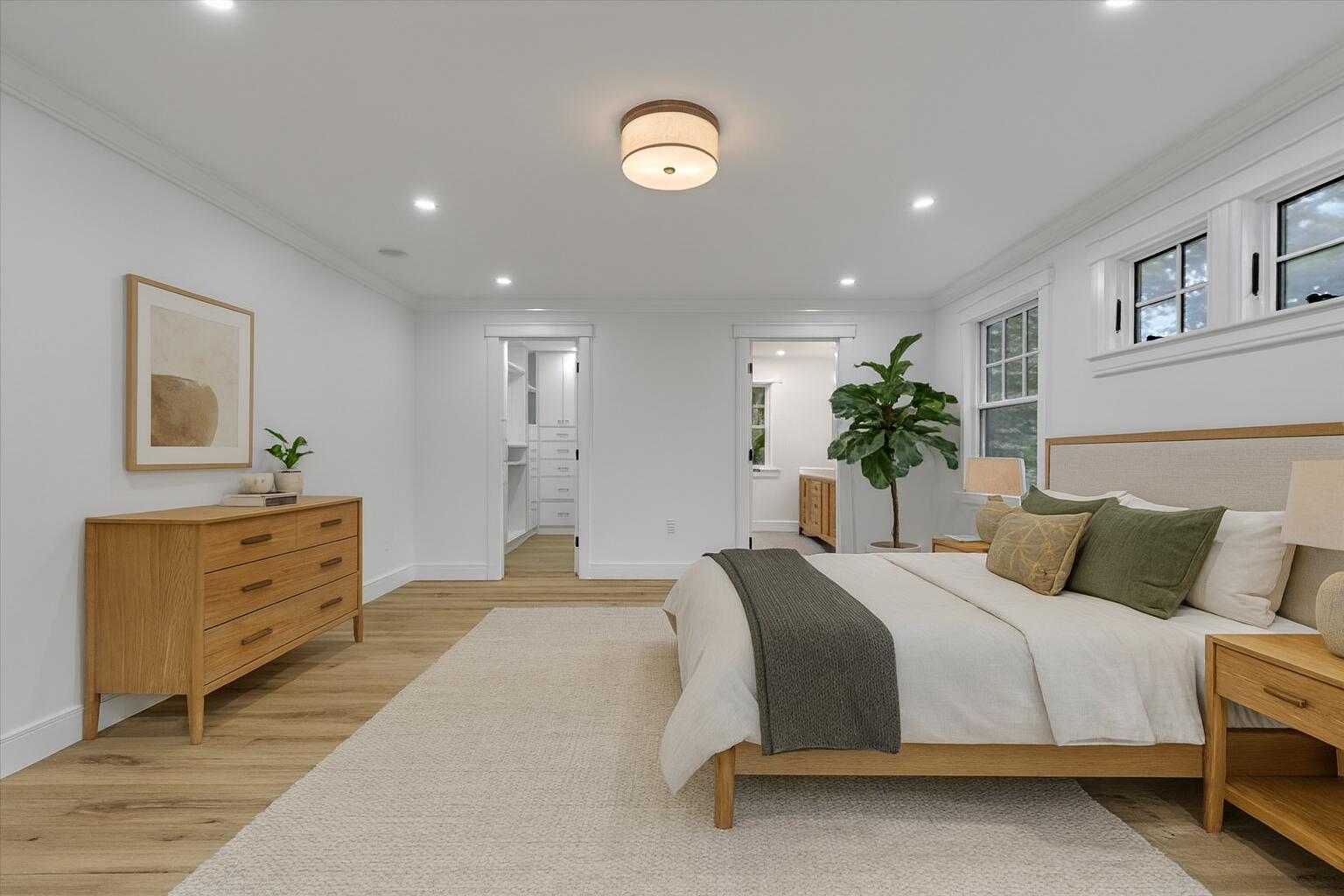 152 Pleasant Bay Road Harwich, MA 02645 - Photo 4 of 97 a bedroom with a large bed and a chandelier