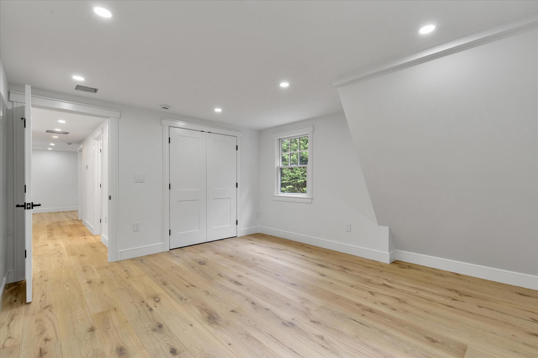 152 Pleasant Bay Road Harwich, MA 02645 - Photo 54 of 97 an empty room with wooden floor and window