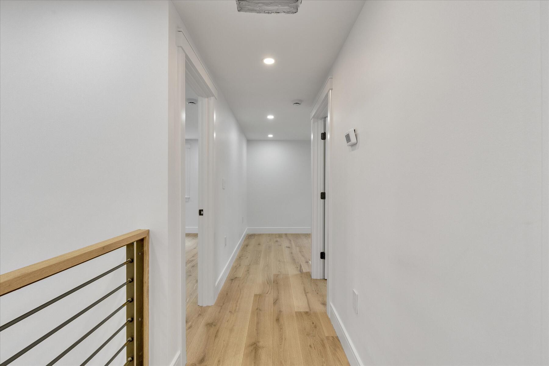 152 Pleasant Bay Road Harwich, MA 02645 - Photo 57 of 97 a view of a hallway with wooden floor and a bathroom