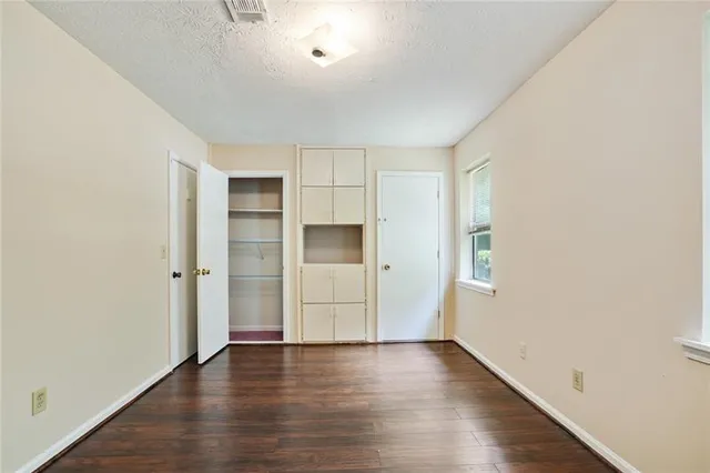 an empty room with wooden floor