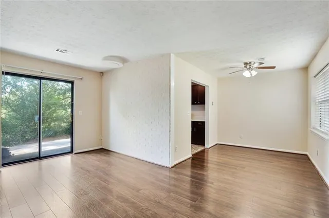 wooden floor in an empty room with a window