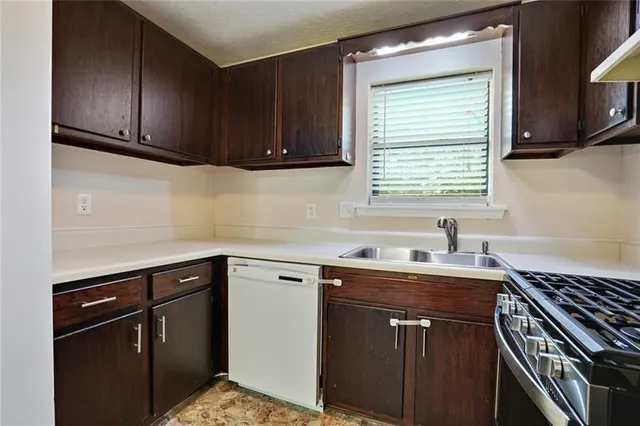 a kitchen with a sink cabinets and window