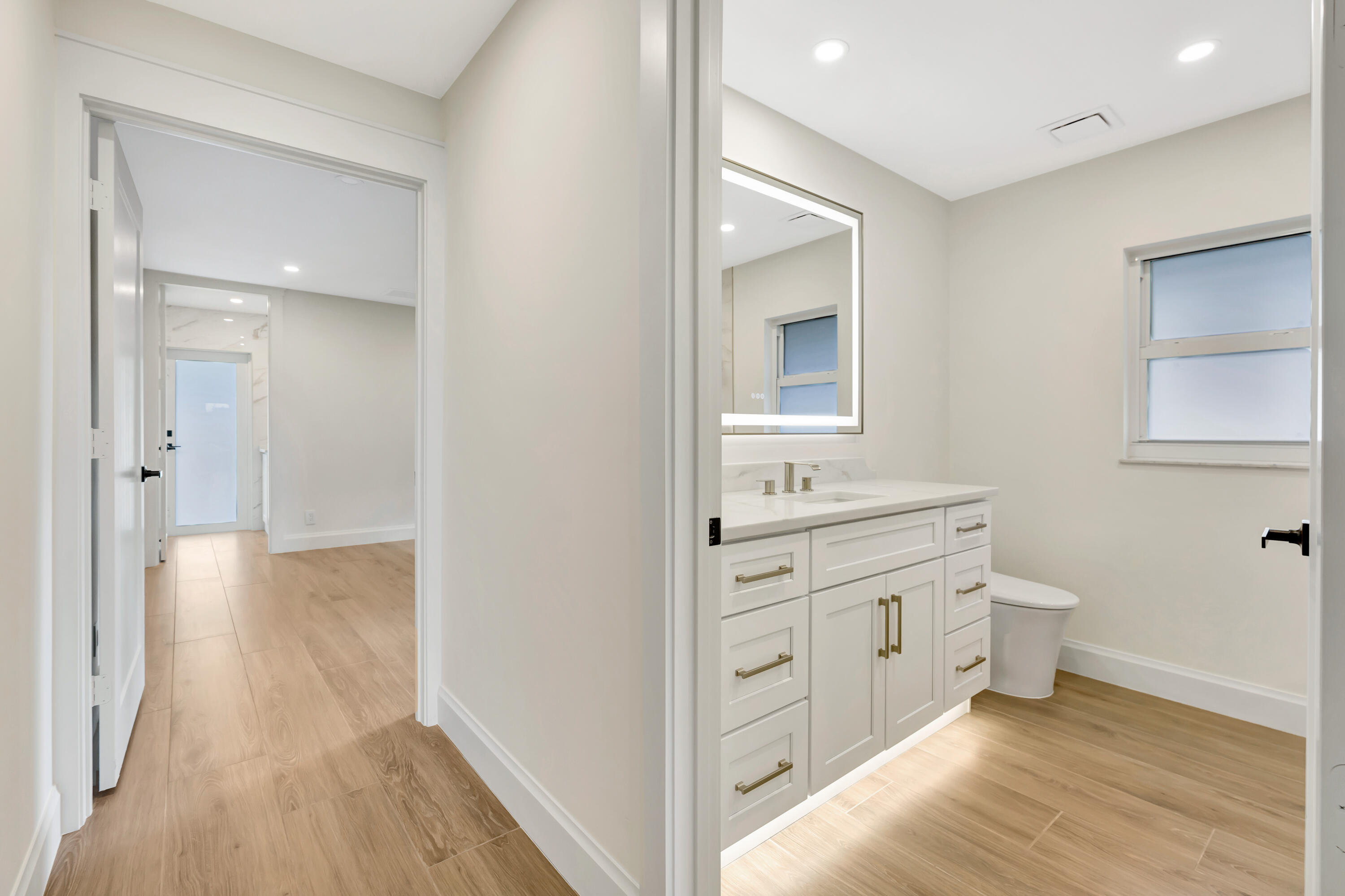 3984 Southeast Fairway East Stuart, FL 34997 - Photo 11 of 40 a bathroom with a granite countertop sink toilet a mirror and vanity
