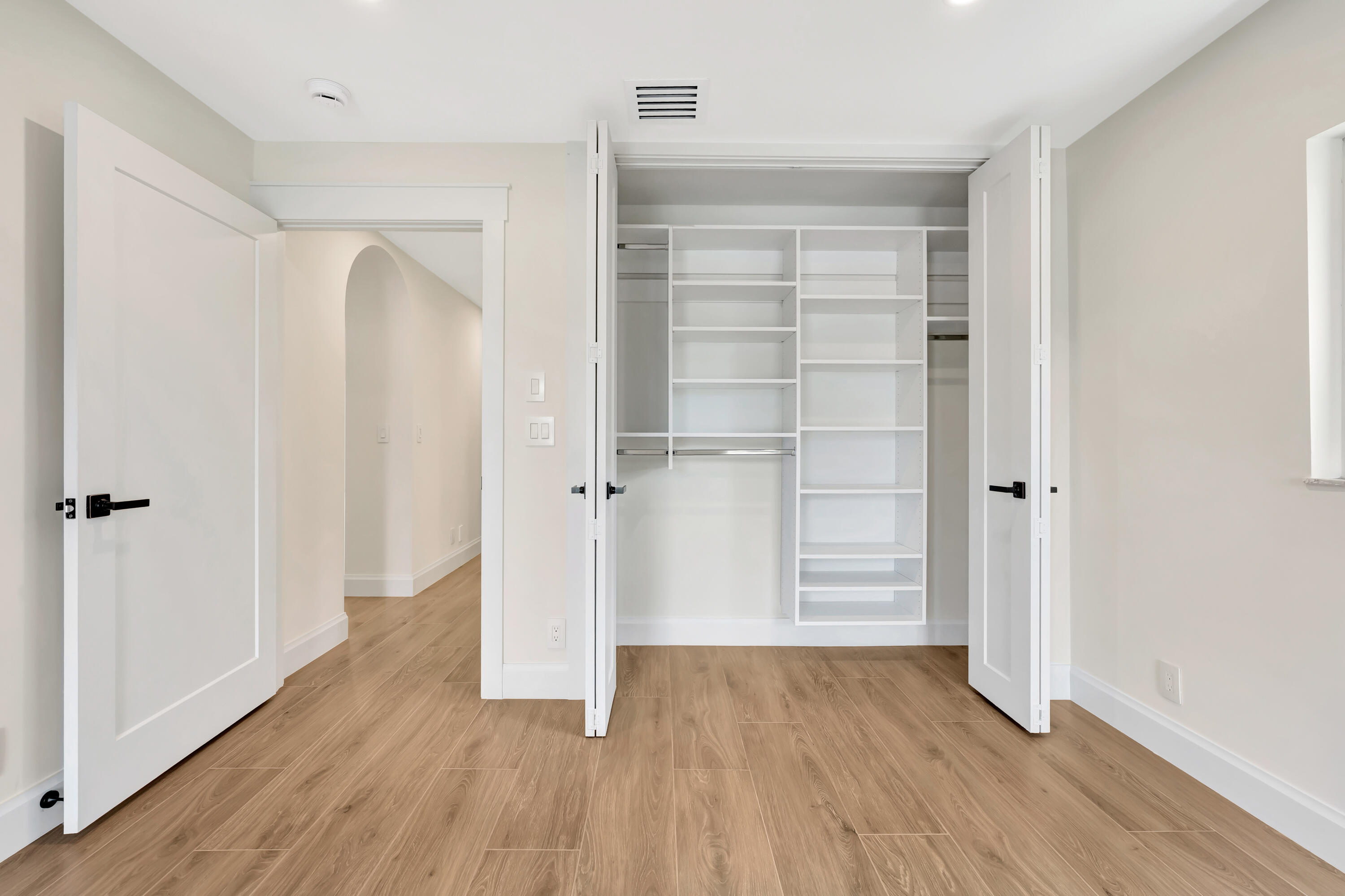 3984 Southeast Fairway East Stuart, FL 34997 - Photo 18 of 40 a view of walk in closet with wooden floor