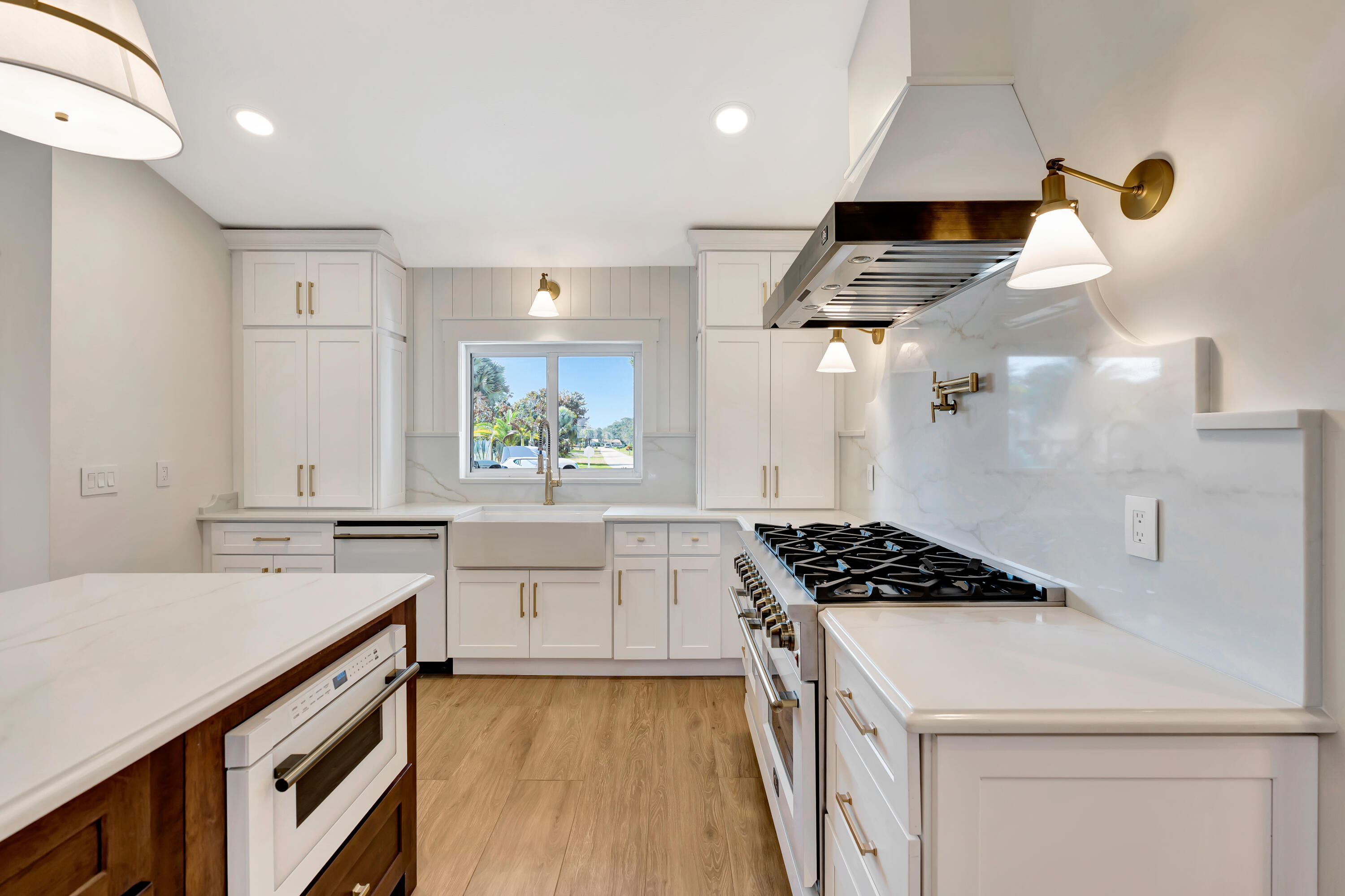 3984 Southeast Fairway East Stuart, FL 34997 - Photo 2 of 40 a kitchen with a stove a sink and a refrigerator