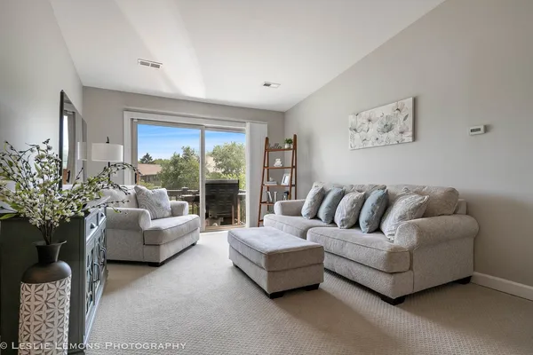a living room with furniture and a large window