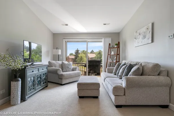 a living room with furniture and a large window