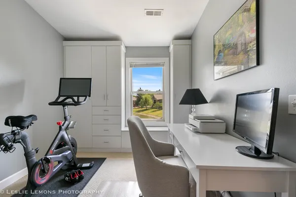 a work room with furniture and a flat screen tv