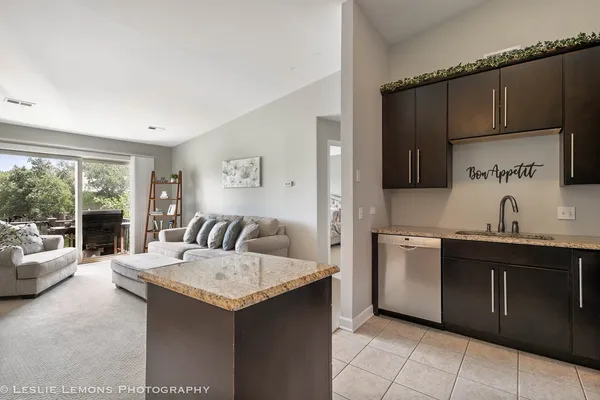a kitchen with granite countertop a sink and a stove top oven