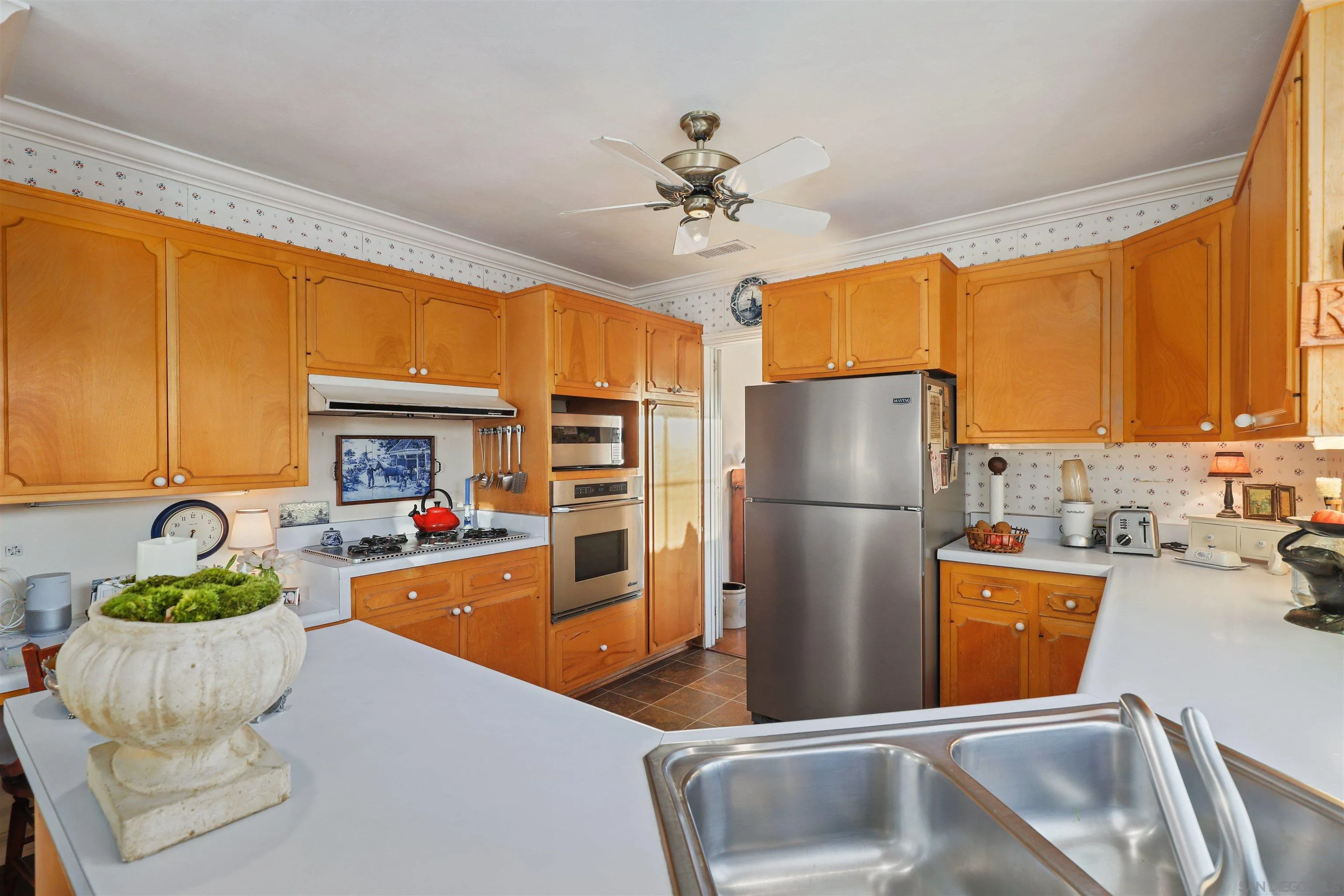 6029 Waverly Avenue La Jolla, CA 92037 - Photo 13 of 48 a kitchen with sink refrigerator and cabinets