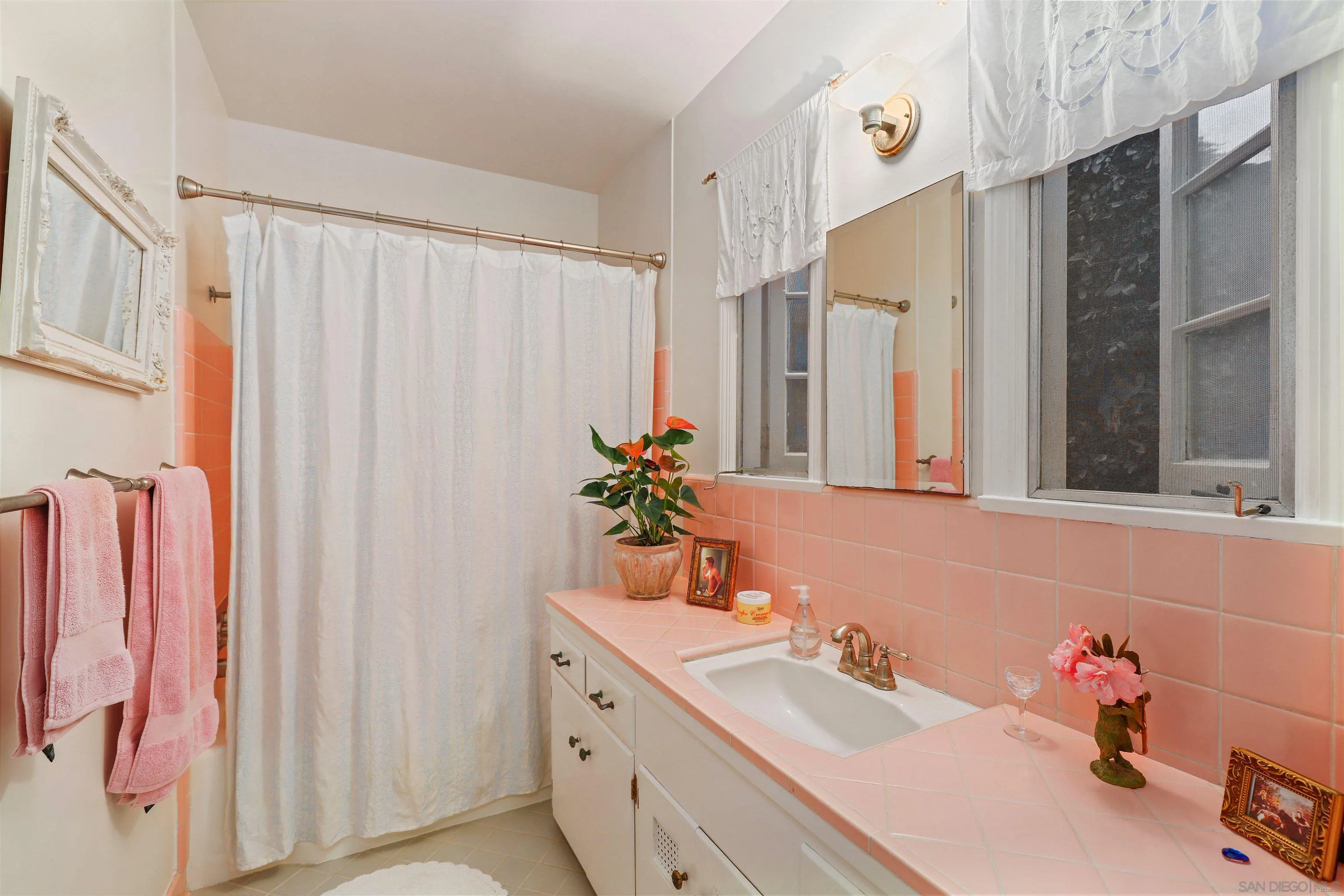6029 Waverly Avenue La Jolla, CA 92037 - Photo 25 of 48 a bathroom with shower sink and a mirror