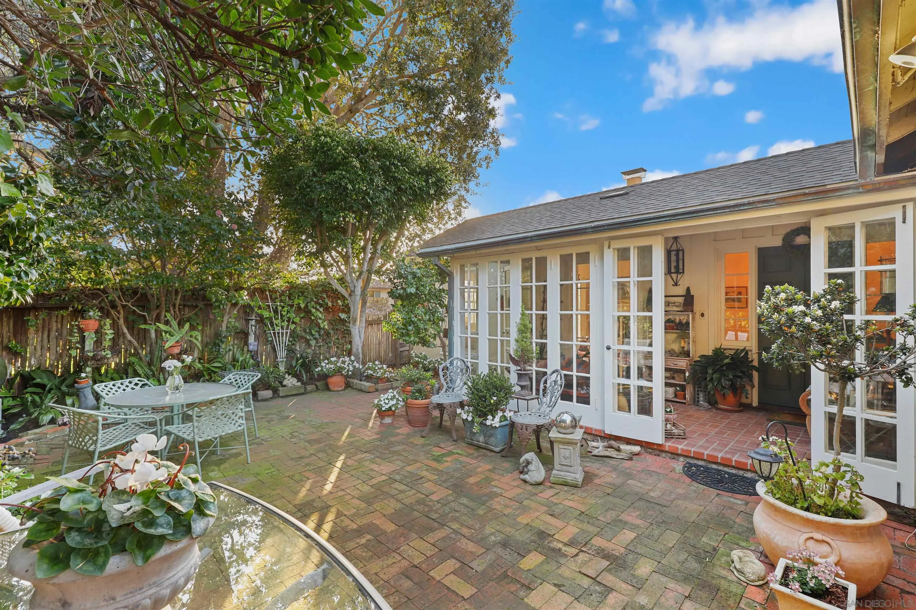 6029 Waverly Avenue La Jolla, CA 92037 - Photo 34 of 48 a view of a patio with table and chairs potted plants and large tree