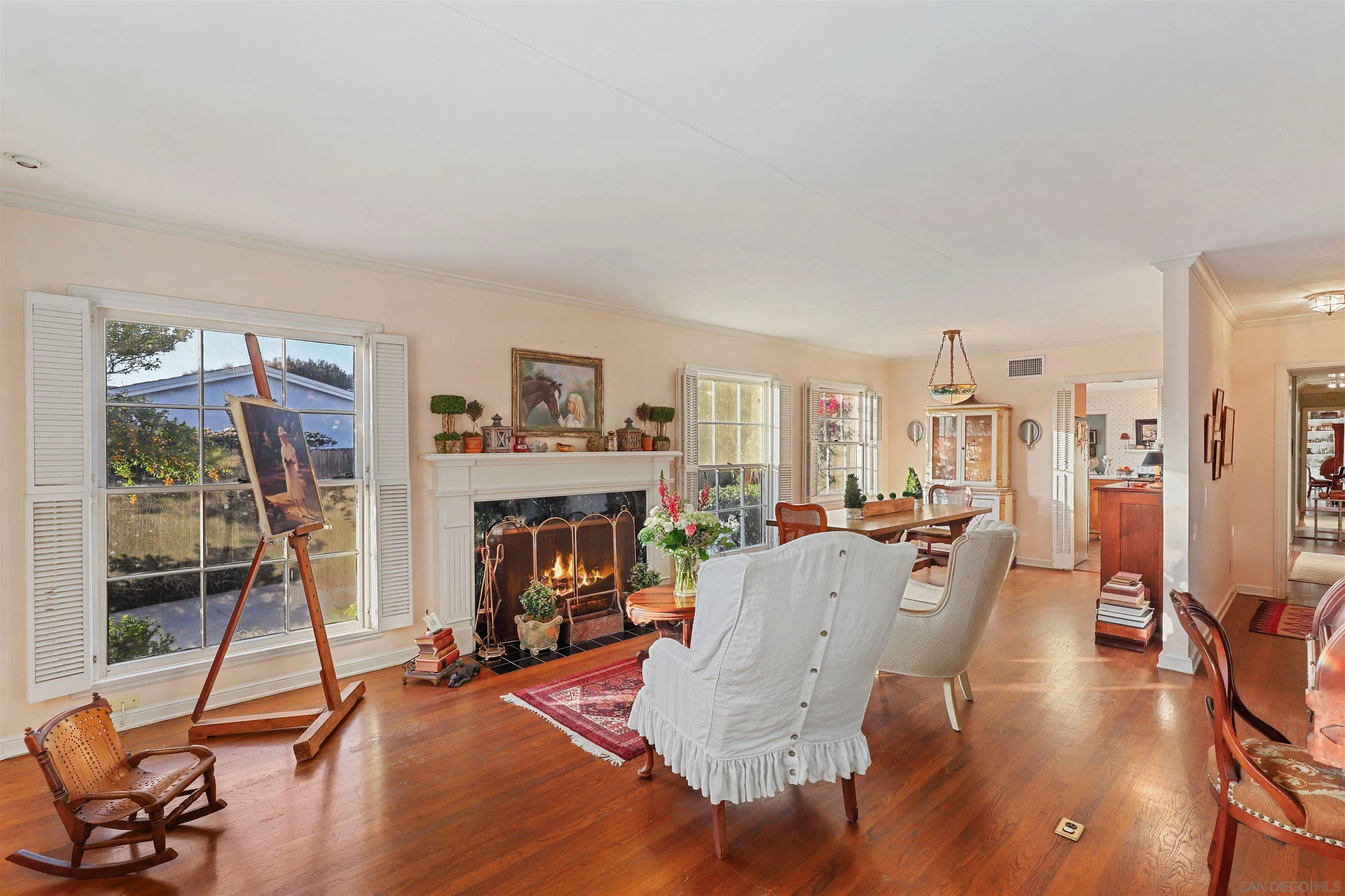 6029 Waverly Avenue La Jolla, CA 92037 - Photo 9 of 48 a living room with furniture a fireplace and a floor to ceiling window