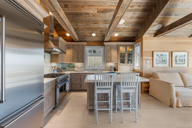 a kitchen with stainless steel appliances granite countertop a stove and a refrigerator