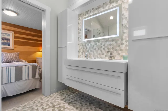 a bathroom with a granite countertop sink a toilet and shower