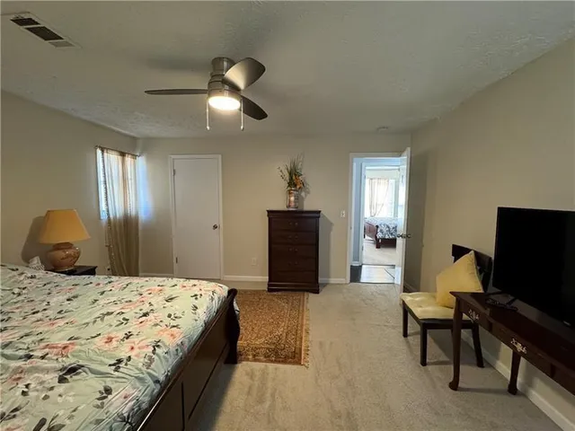 a bedroom with a bed and a television