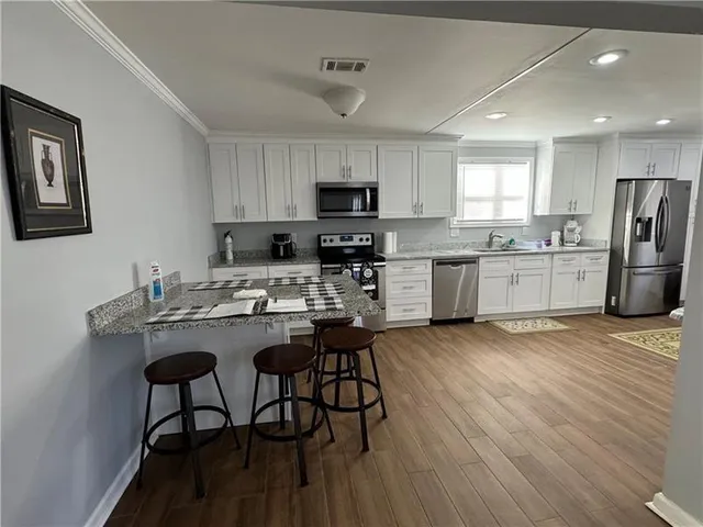 a kitchen with refrigerator and microwave