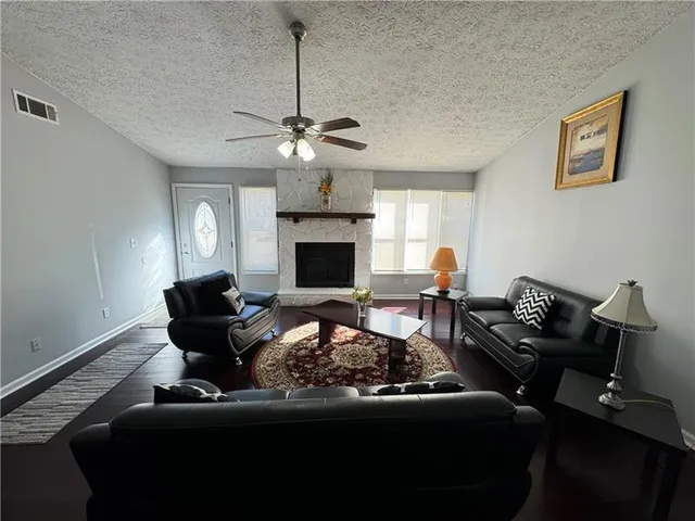 a living room with furniture or chandelier and a fireplace