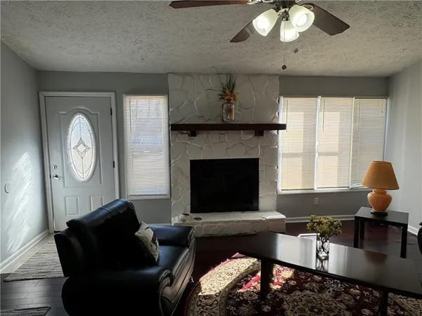 a living room with furniture and a fireplace