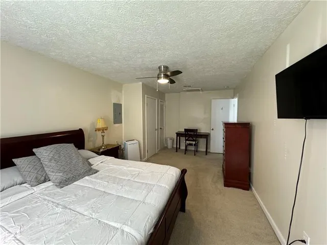 a bedroom with a bed and a flat screen television