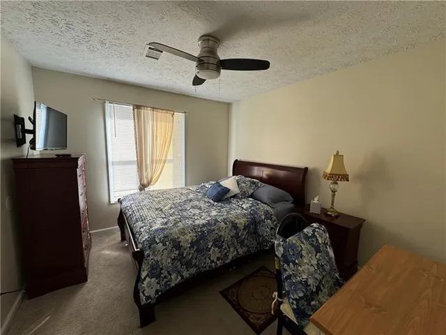 a bedroom with a bed and window