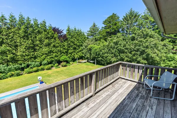a view of balcony with wooden floor and fence