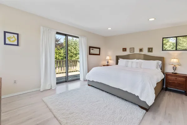 a bedroom with a large bed and a window