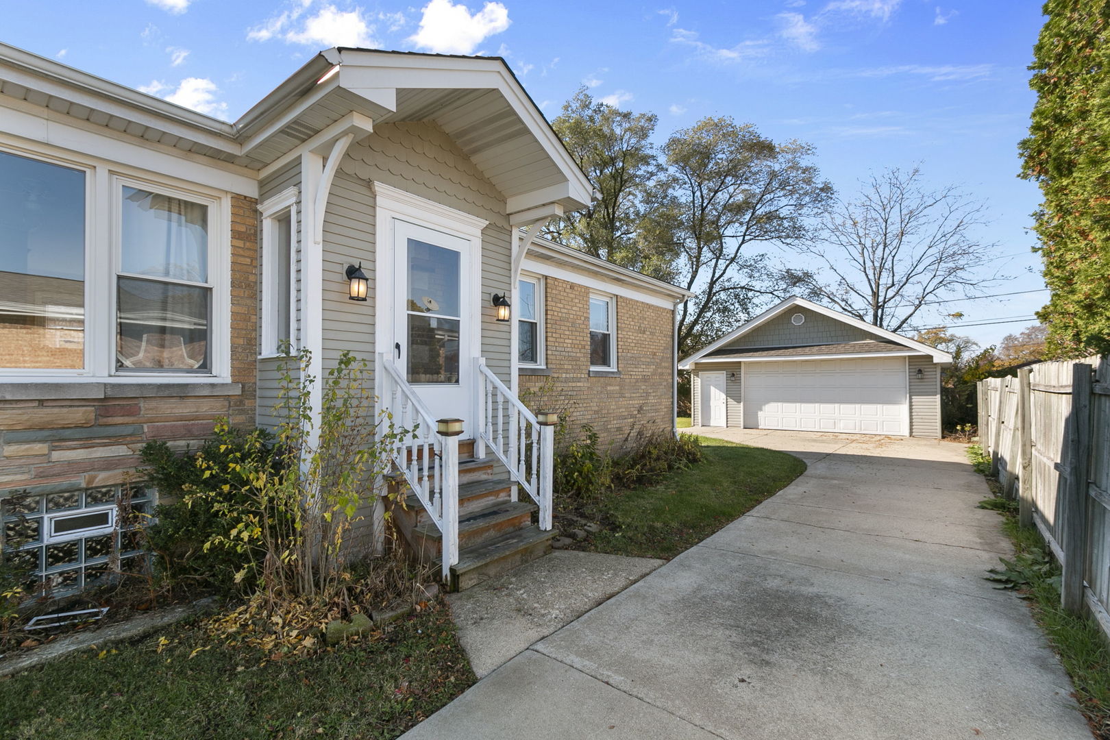 a view of a brick house with many windows next to a yard