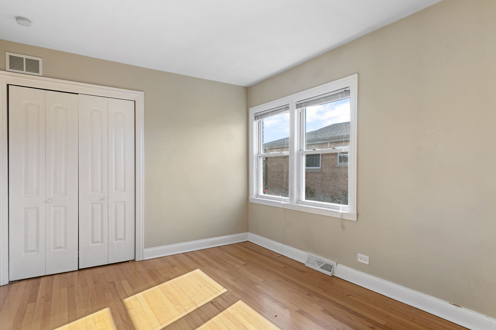 8152 Mayfield Avenue Burbank, IL 60459 - Photo 11 of 21 a view of an empty room with wooden floor and a window