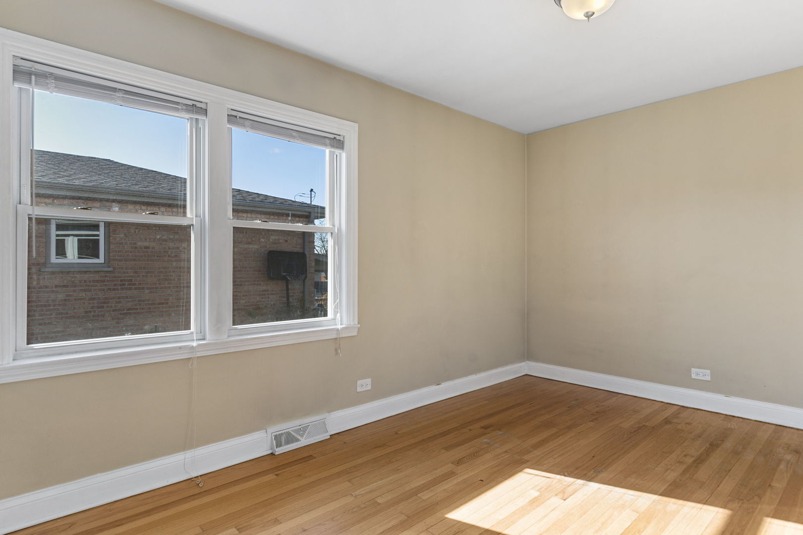 8152 Mayfield Avenue Burbank, IL 60459 - Photo 12 of 21 a view of empty room with wooden floor and fan