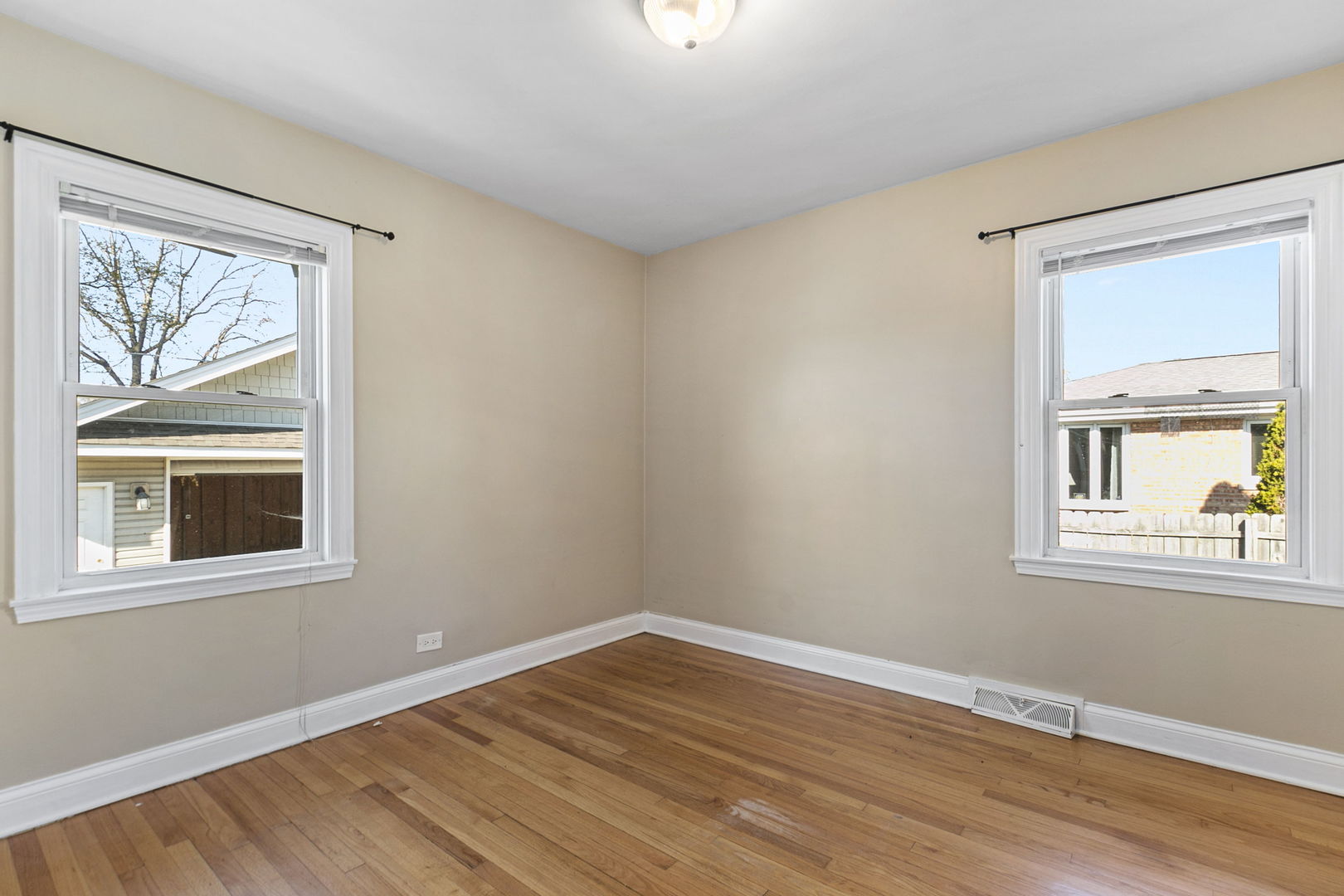 8152 Mayfield Avenue Burbank, IL 60459 - Photo 13 of 21 a view of an empty room with wooden floor and a window