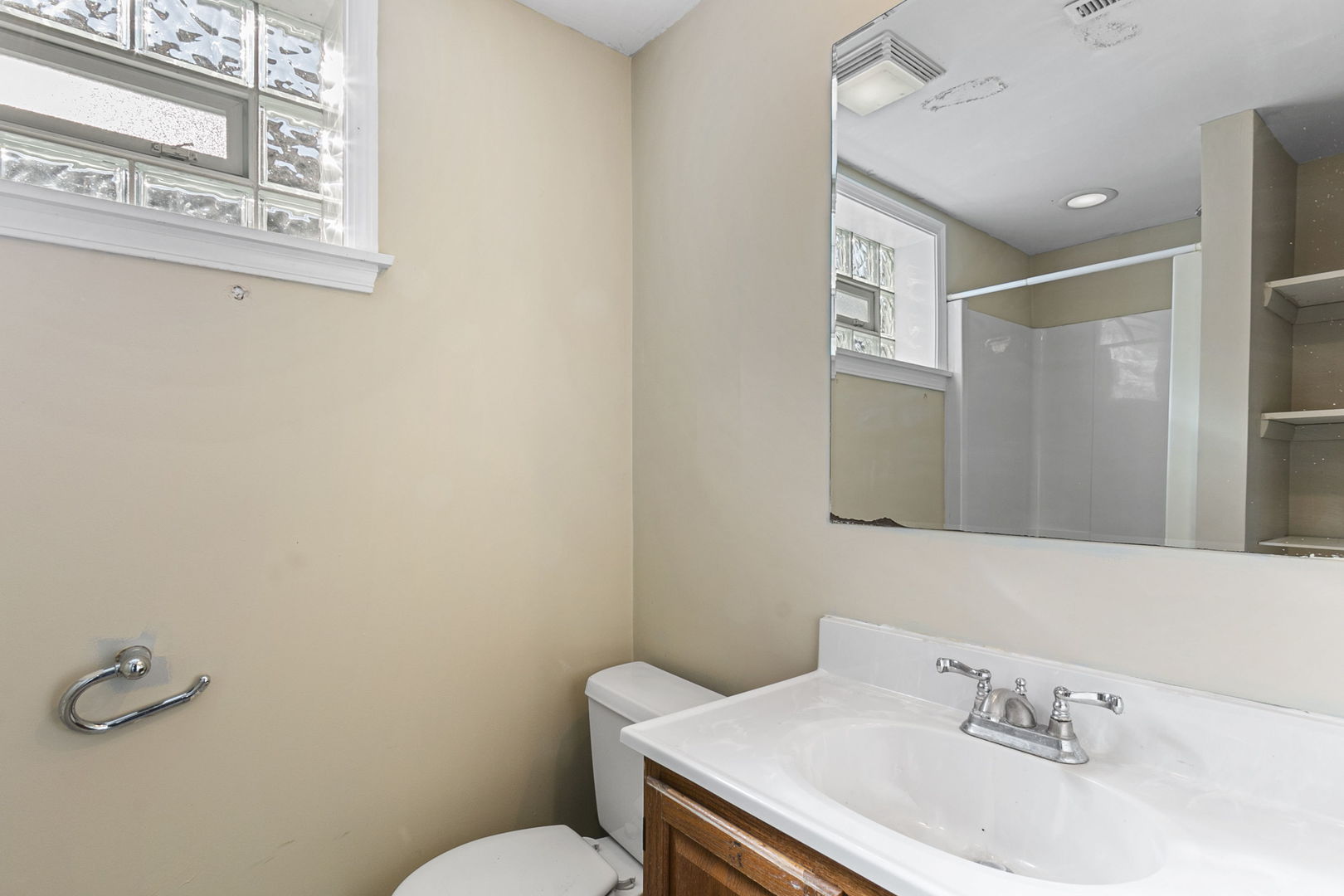 8152 Mayfield Avenue Burbank, IL 60459 - Photo 18 of 21 a bathroom with a sink a toilet and a mirror