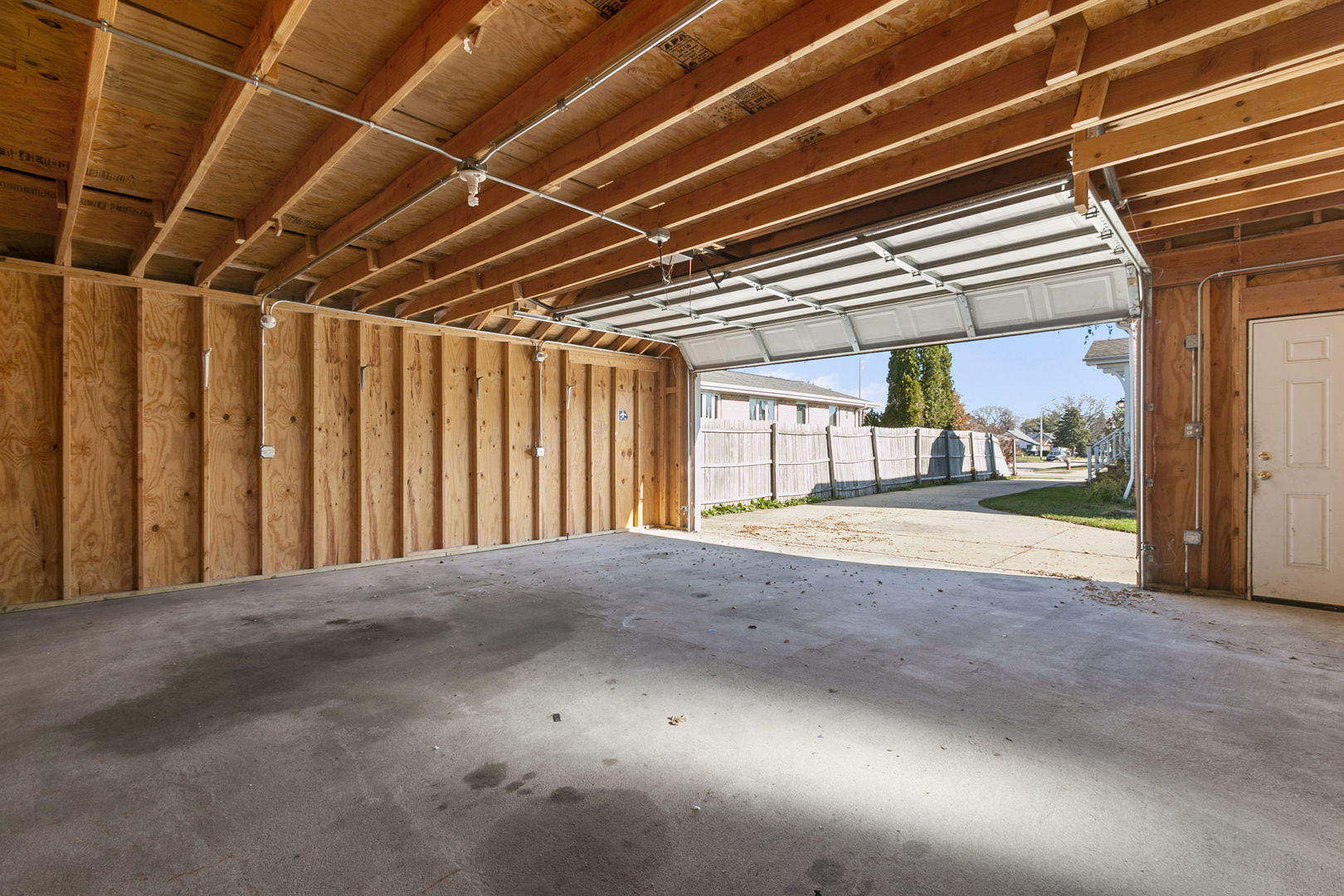 8152 Mayfield Avenue Burbank, IL 60459 - Photo 3 of 21 a view of an empty room with wooden floor and a window
