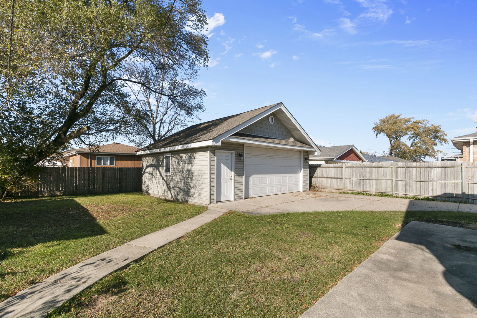 8152 Mayfield Avenue Burbank, IL 60459 - Photo 5 of 21 a front view of a house with a yard and garage