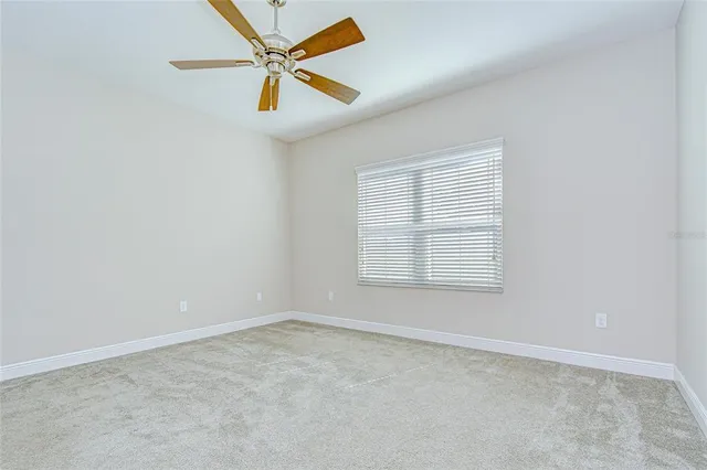a view of a room with a ceiling fan
