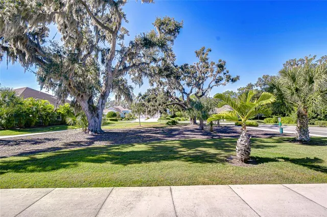 a view of yard with swimming pool and green space