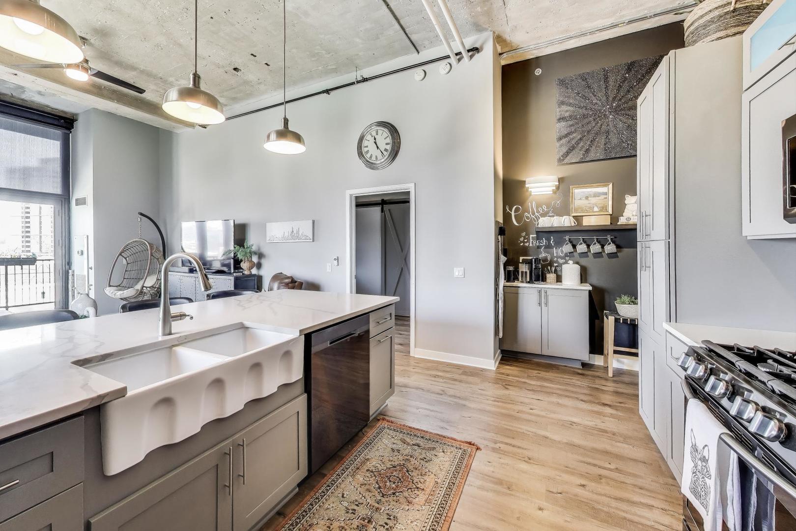 320 East 21st Street, Unit 501 Chicago, IL 60616 - Photo 6 of 22 a kitchen with stainless steel appliances a sink and a refrigerator