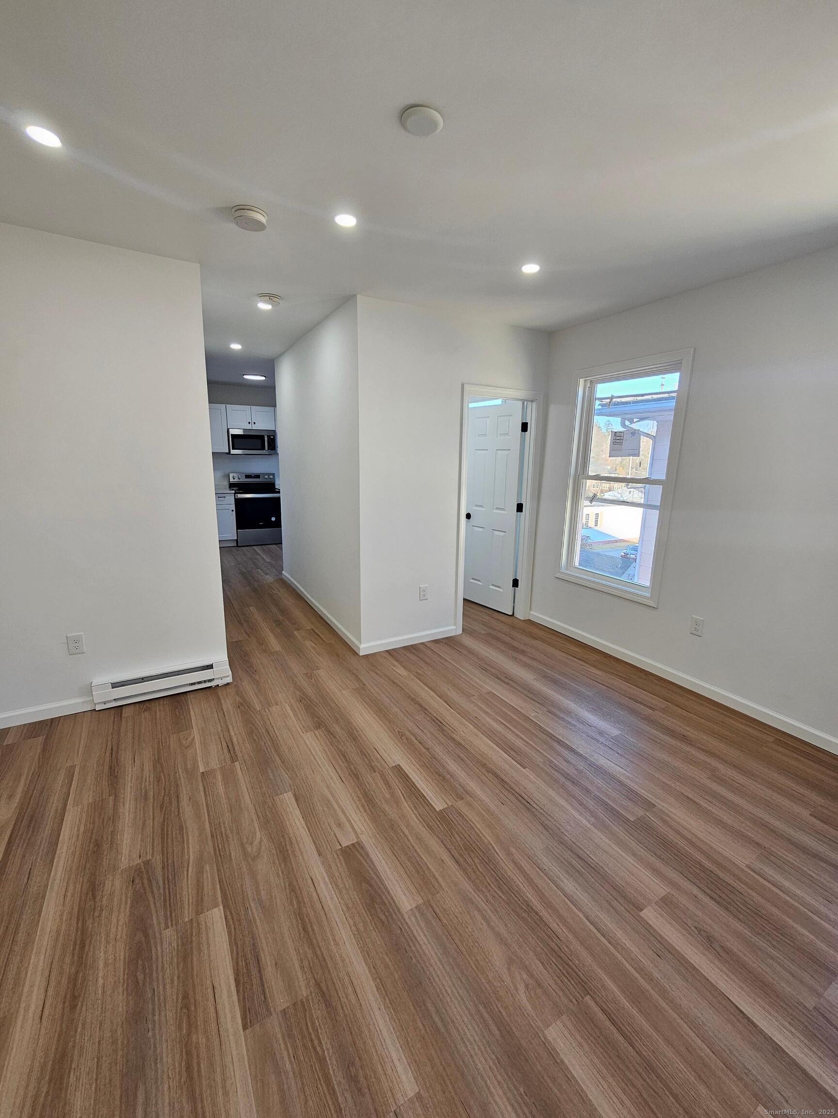 1153 Main Street, Unit 3A Windham, CT 06226 - Photo 7 of 13 Easy flow from the kitchen to the living room and bathroom