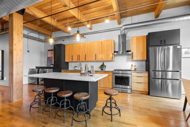 a kitchen with a sink appliances and cabinets