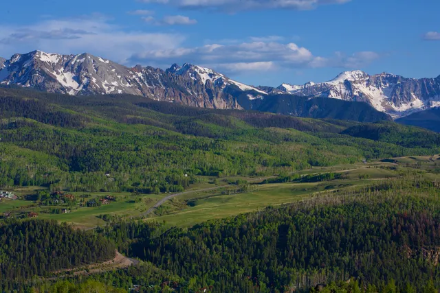 a view of a town with mountains in the background