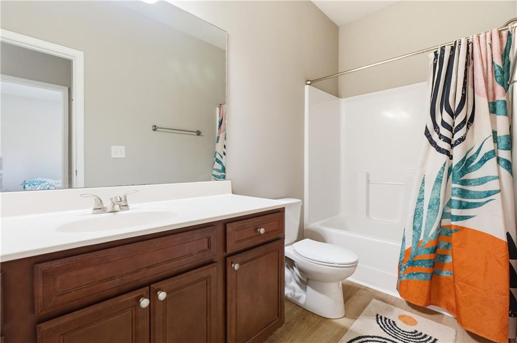 4479 Clubside Drive Gainesville, GA 30504 - Photo 16 of 47 a bathroom with a sink a toilet and a mirror