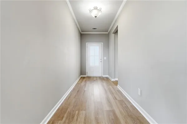 a view of a hallway with wooden floor