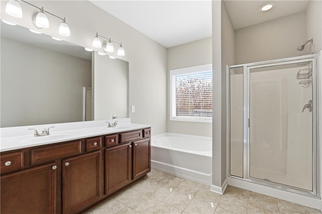 4479 Clubside Drive Gainesville, GA 30504 - Photo 22 of 47 a spacious bathroom with a tub sink shower and mirror