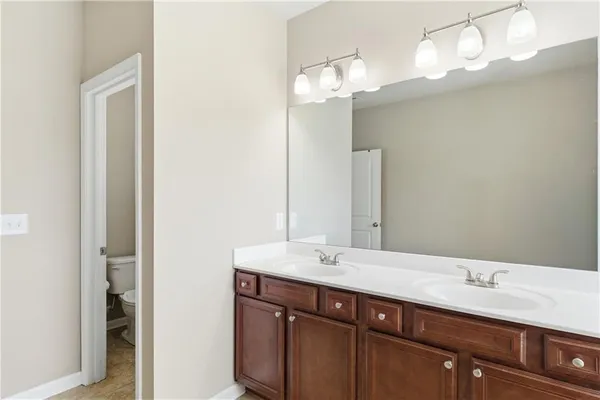 a bathroom with a double vanity sink and a mirror