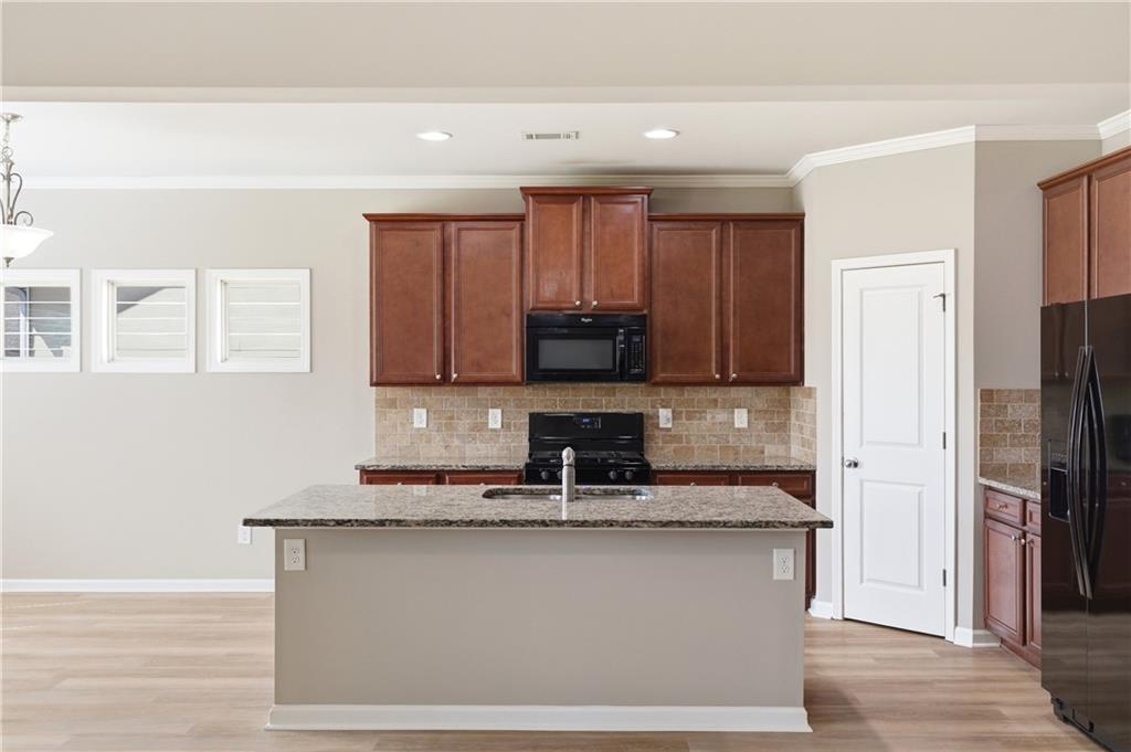 4479 Clubside Drive Gainesville, GA 30504 - Photo 31 of 47 a kitchen with stainless steel appliances granite countertop a refrigerator a stove a sink and a microwave