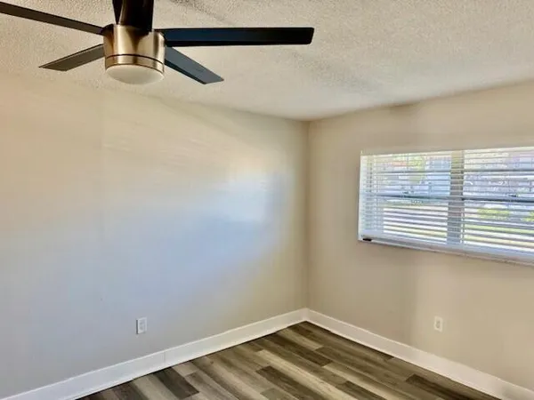 a view of a room with wooden floor and fan