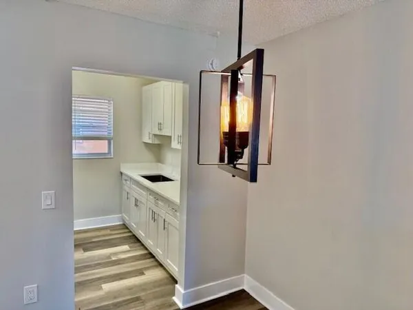 a view of a room with wooden floor and white walls