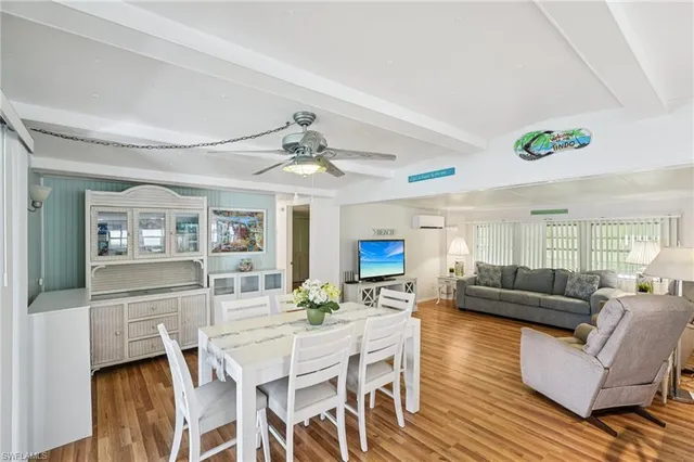 a view of a dining room with furniture a chandelier and wooden floor